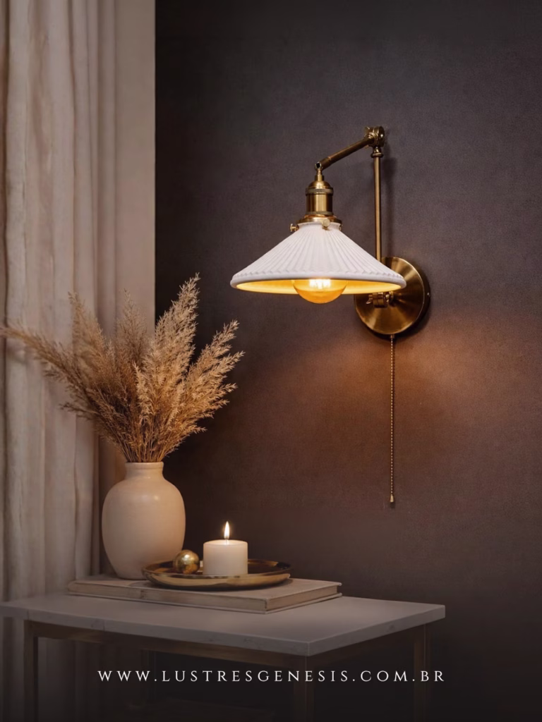 Arandela moderna Araucária em ouro envelhecido instalada na parede, com braço articulado e cúpula branca, ideal para sala de estar, quartos, corredores e área gourmet.