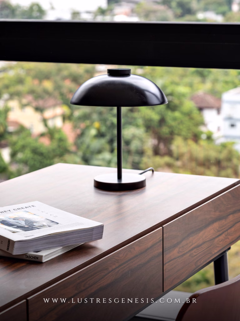 Abajur de LED moderno Sann Ø28cm em acabamento preto, posicionado sobre uma mesa de madeira, ideal para decoração, mesa de cabeceira, cômoda ou canto de leitura.